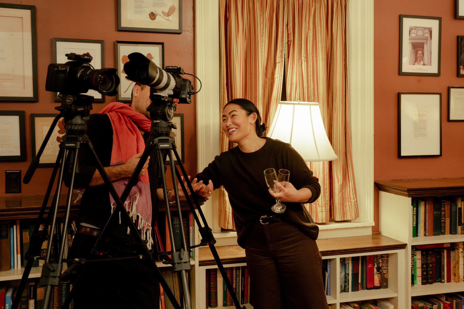 Grace Sun speaking beside two cinema cameras during production.
