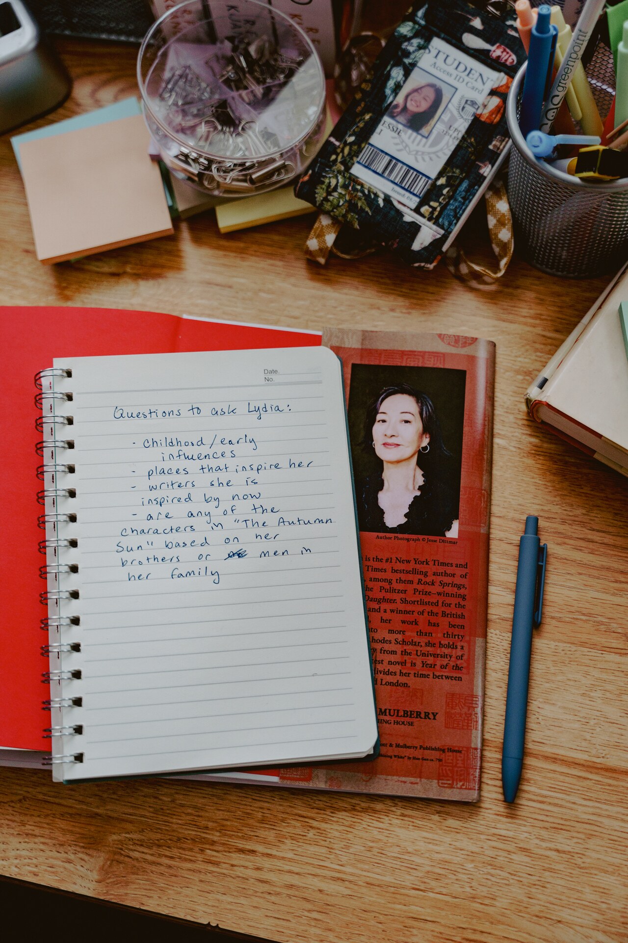 Notebook of handwritten film notes beside a camera and production materials.