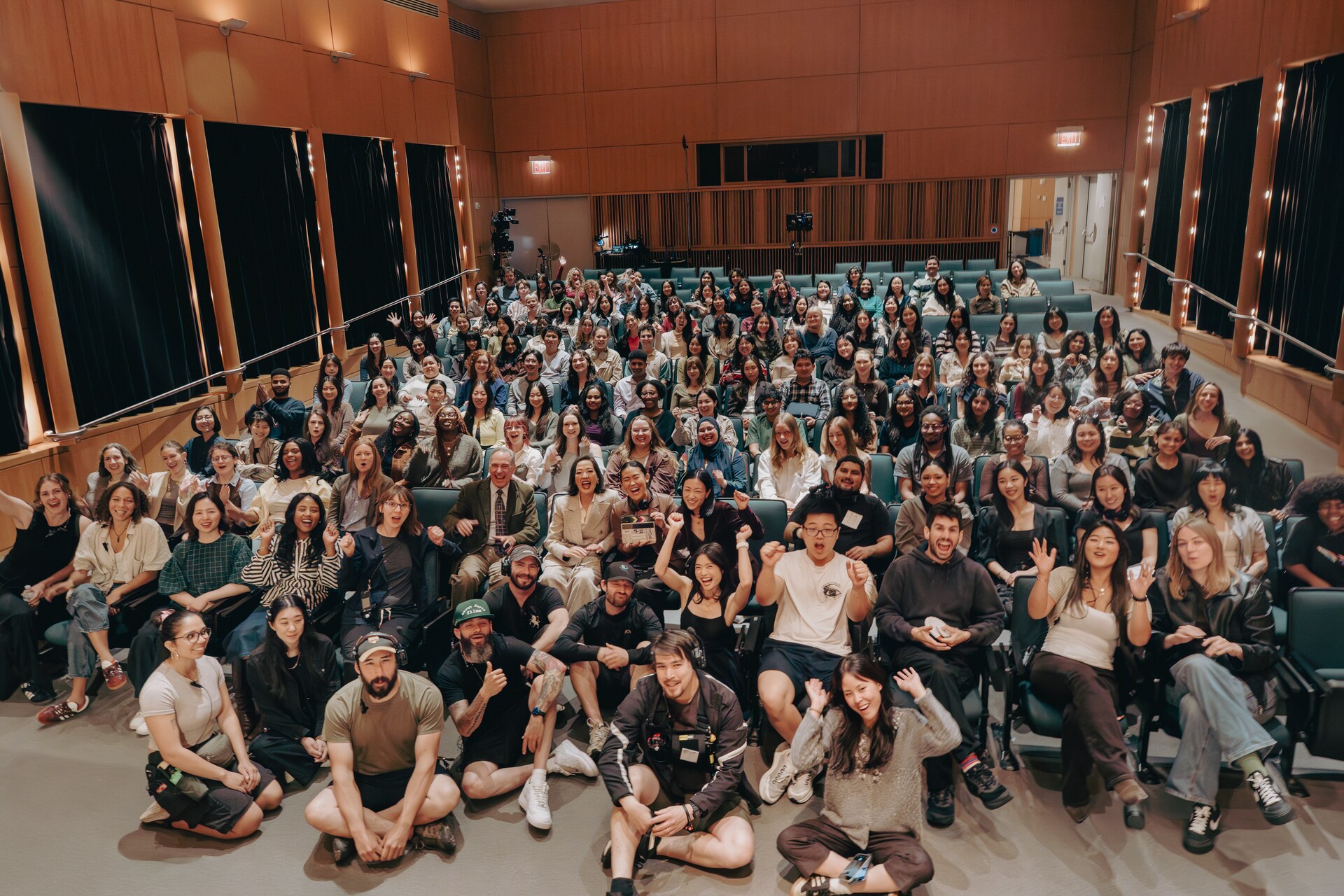 Large Book Talk cast and crew group portrait in an auditorium.