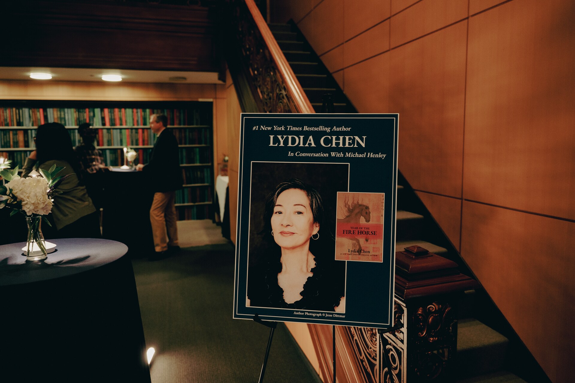 Lydia Chen author poster and table arrangement inside the Book Talk location.