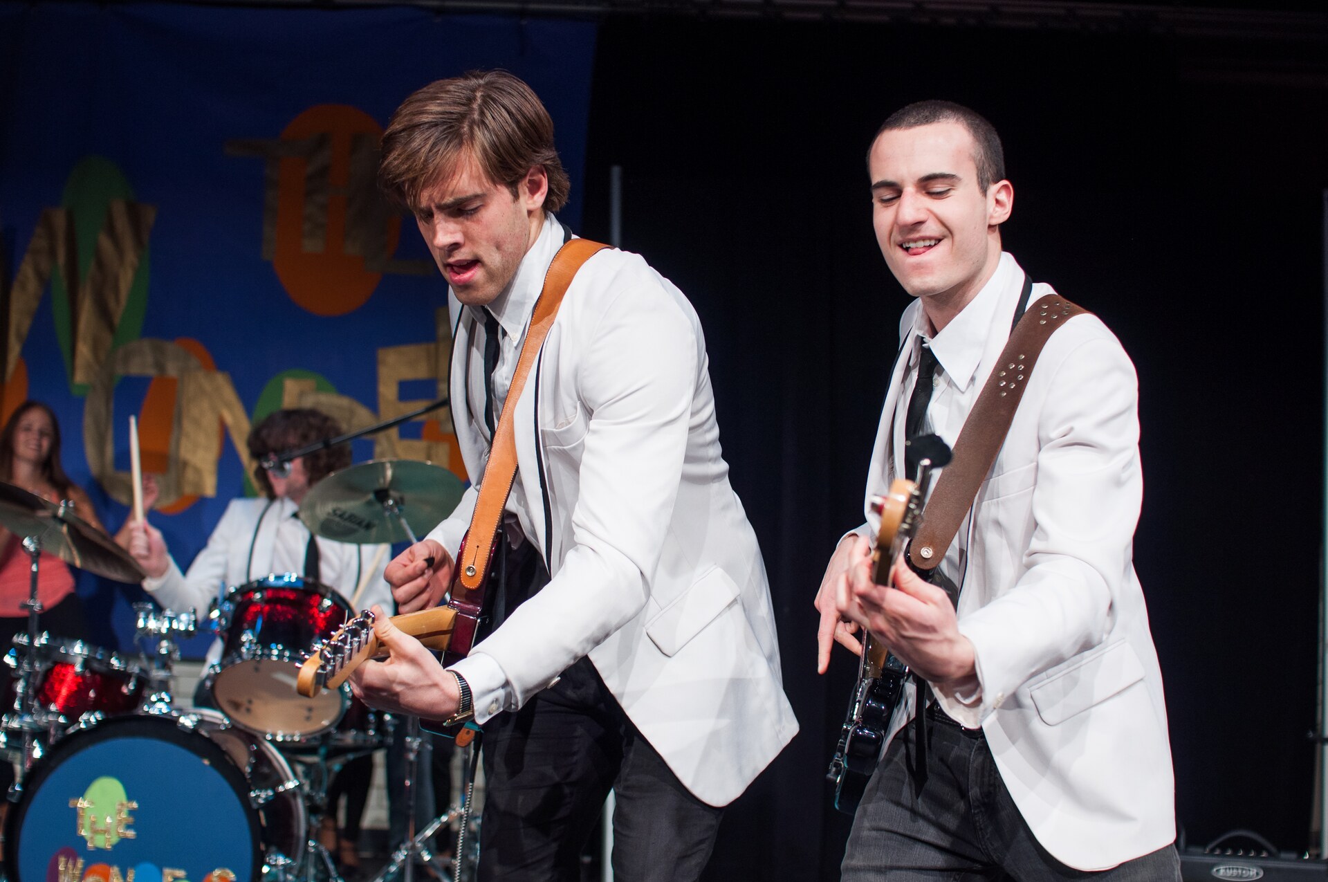 Actors playing guitar and drums during the That Thing You Do stage production.