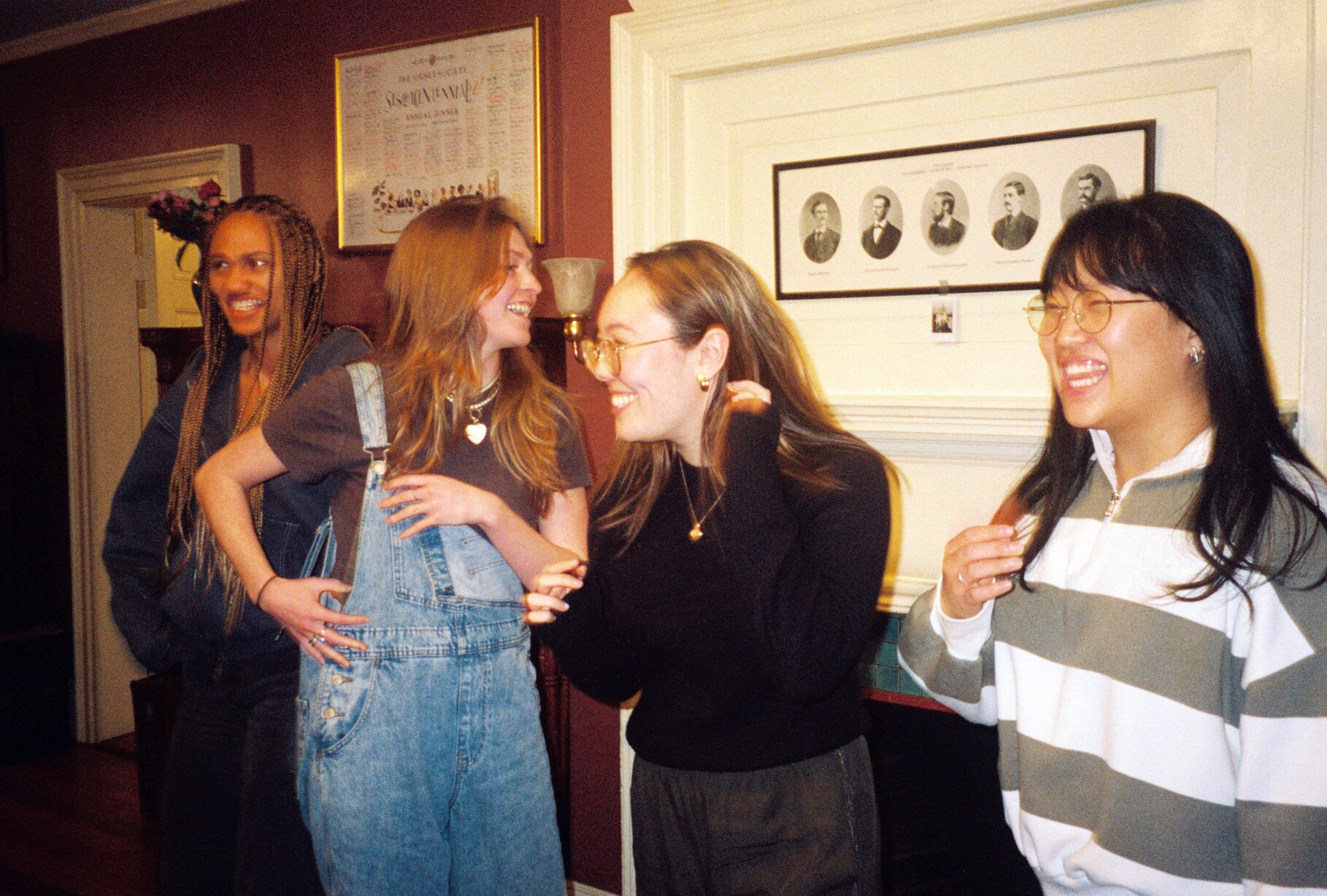 Four women laughing and talking in the Signet Library during filming.