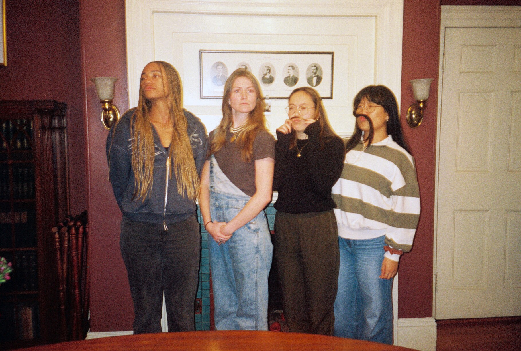 Four women standing together in the Signet Library in a 35mm production photograph.