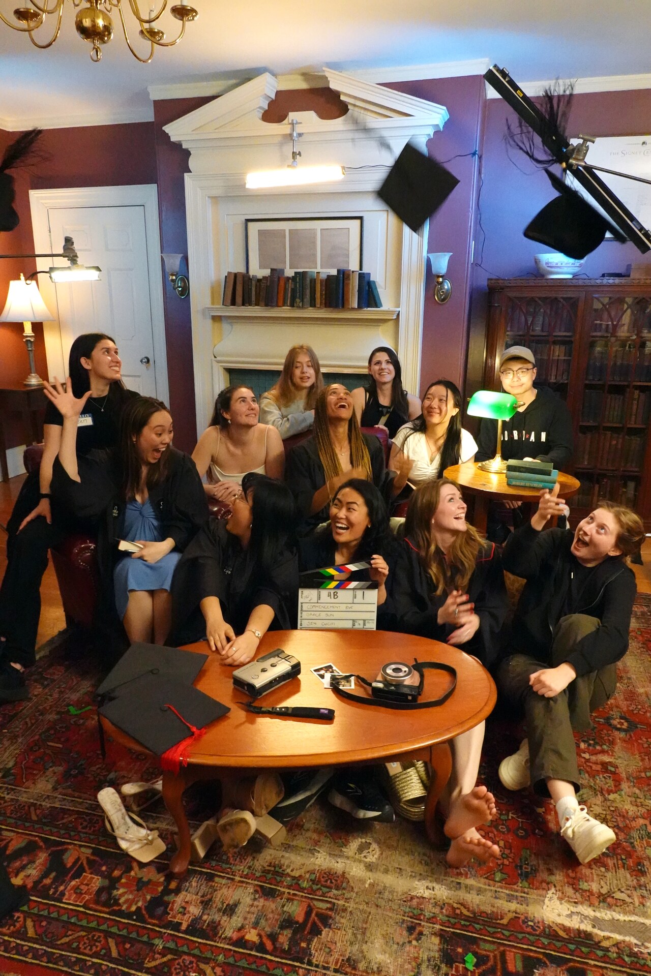 Commencement Eve cast and crew group portrait surrounded by lights and production equipment.
