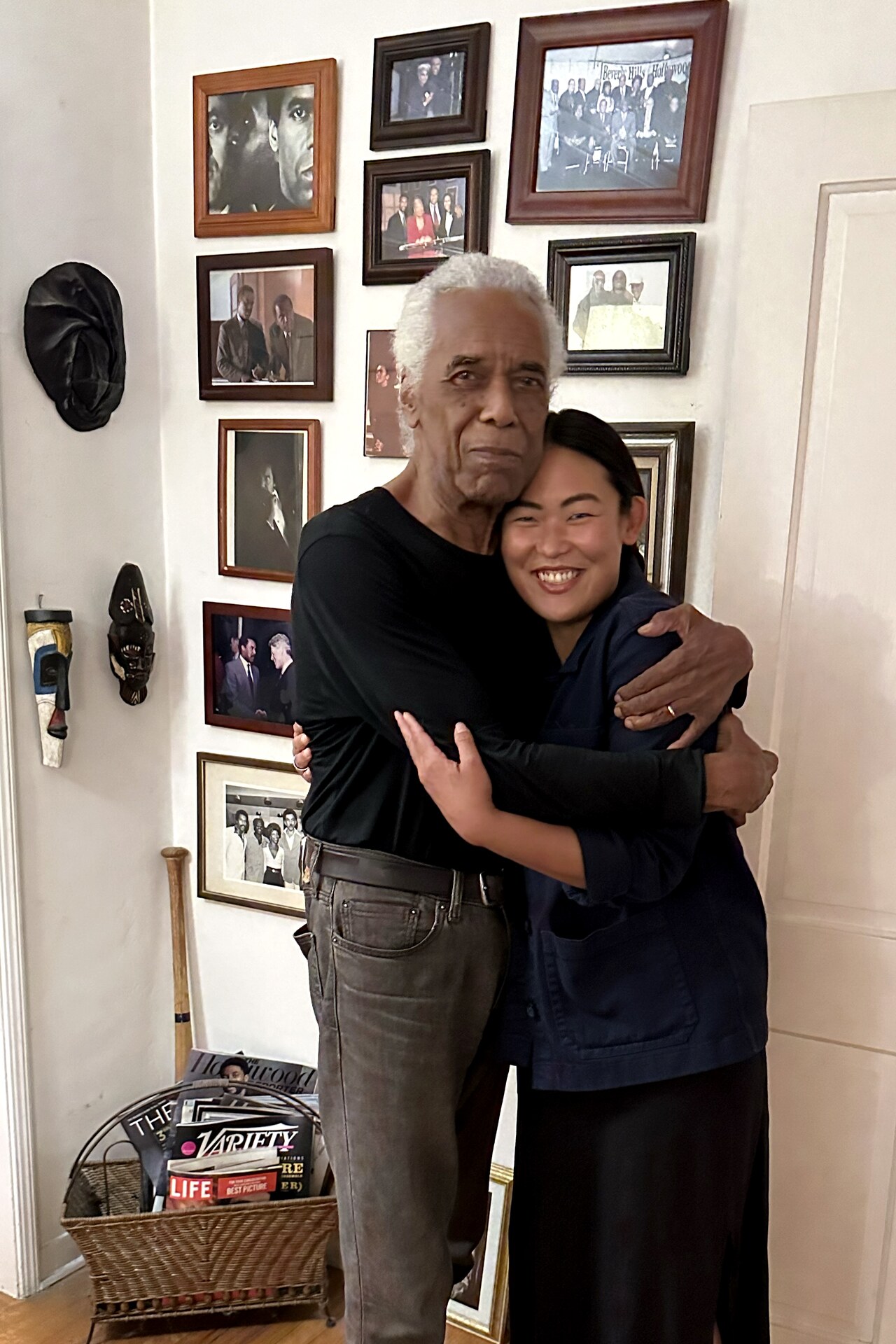 Grace Sun and Robert Hooks embracing in his home.