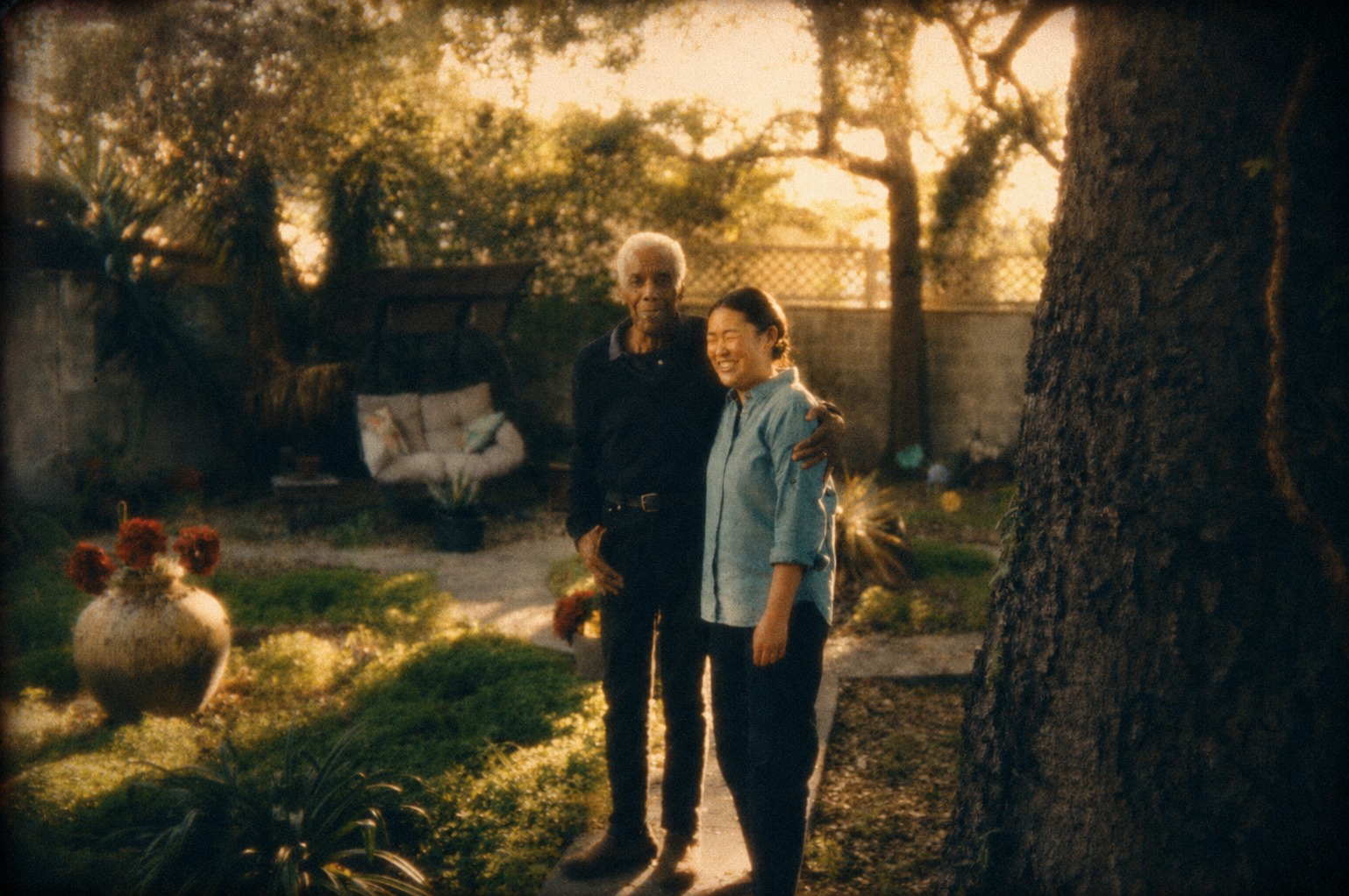 Grace Sunny Sun standing with Robert Hooks in a garden.