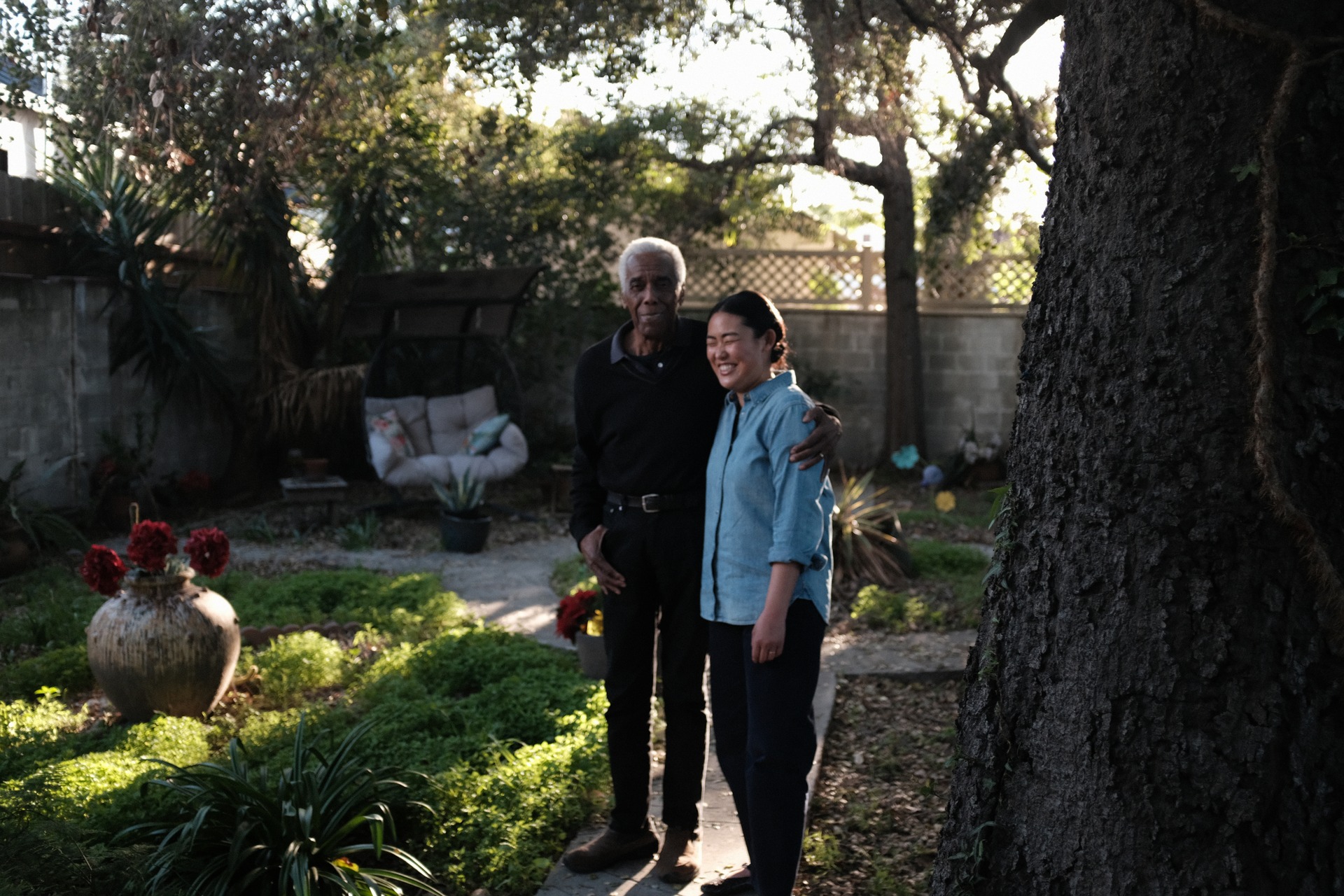 Grace Sunny Sun standing with Robert Hooks in a sunlit garden.